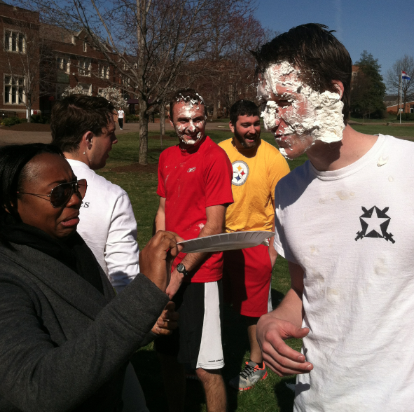 Tim Cywinski being pied during Pie a Pi Kapp by Area Coordinator Kristen Pearson 